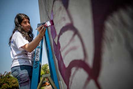 Artist paints mural