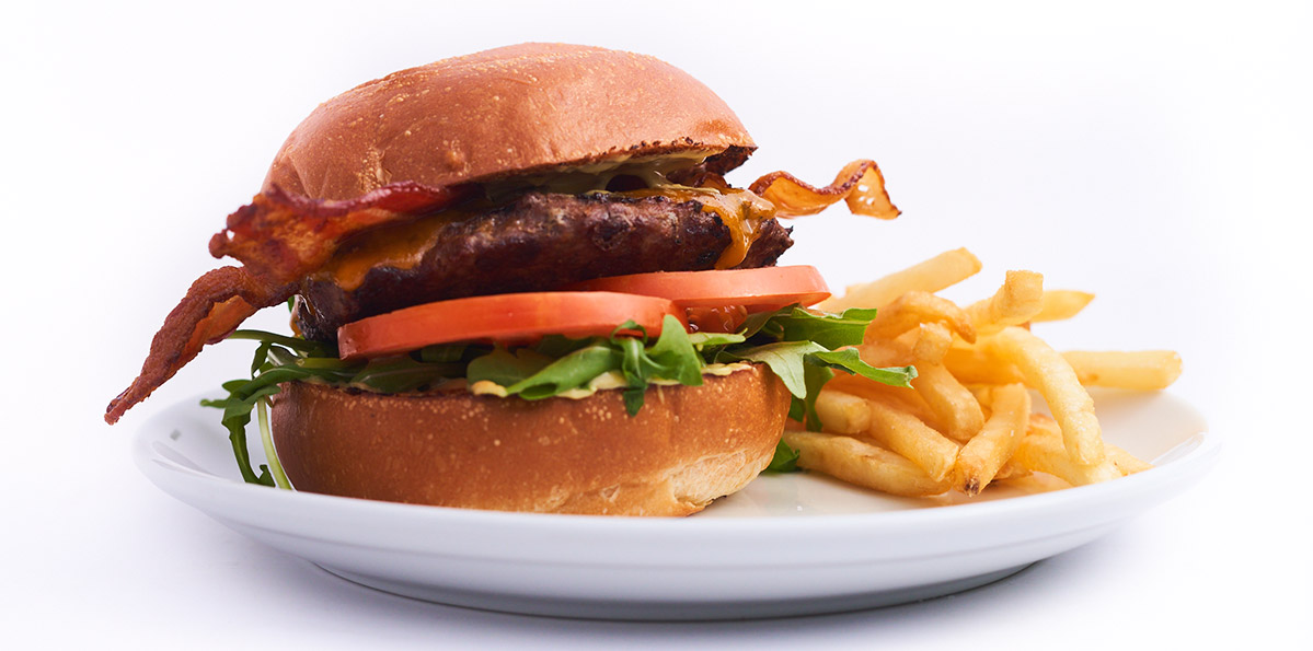 Burger with bacon and a side of french fries.