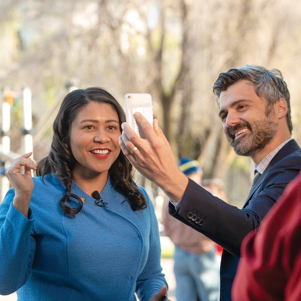 London Breed stops to take photos with city residents while walking to work