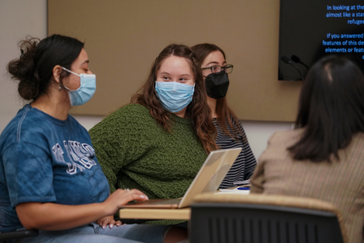 Students look at each other in class. 