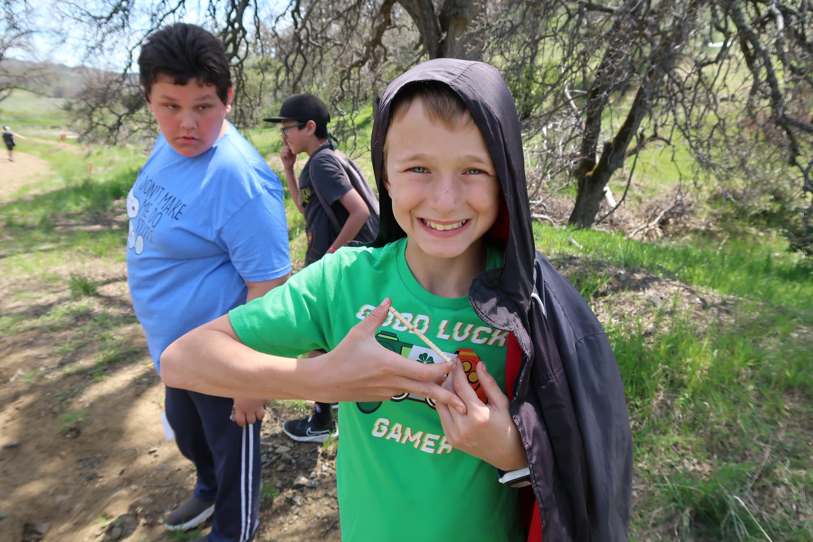 student smiles and poses with a tree core