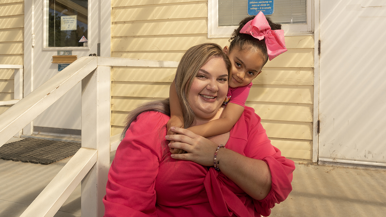 Laicee Brown, with Cienna, her four-year-old daughter, on the steps of the Early Childhood Lab School.