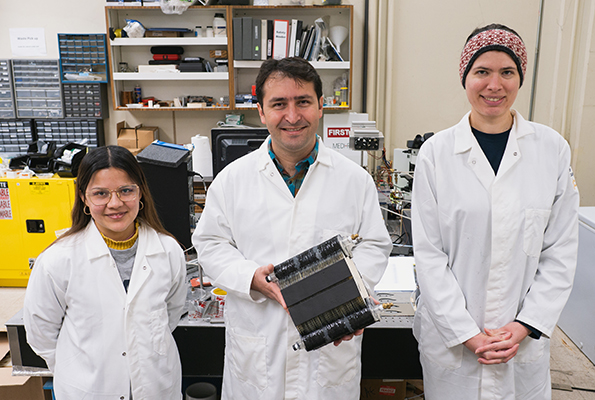 Engineer Erfan Rasouli and students in Bainer Hall holding the patented device. (Paul Fortunato / UC Davis)