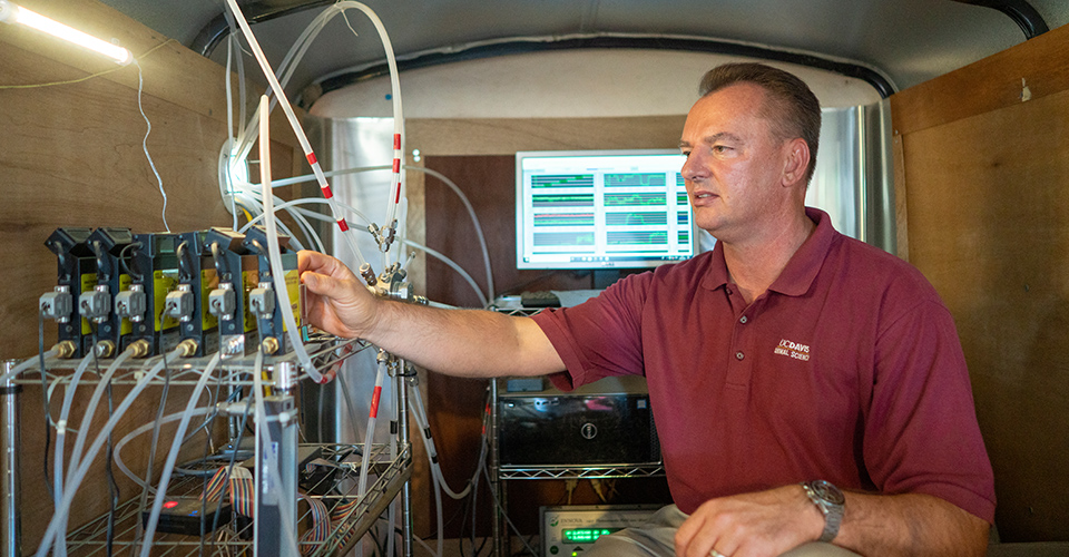 Prof. Mitloehner studying gas data from cows