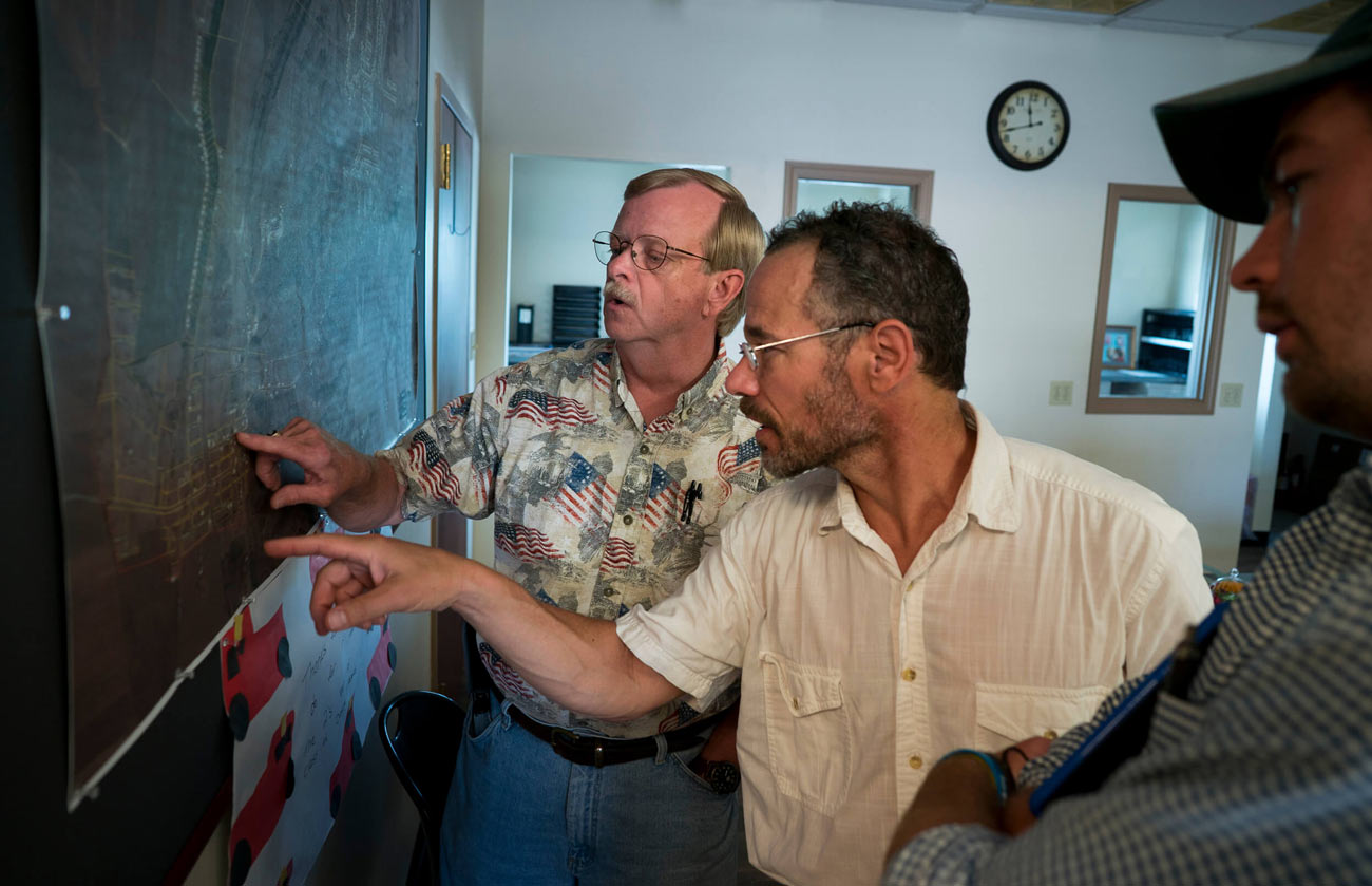 Dennis and Nicholas pointing at board