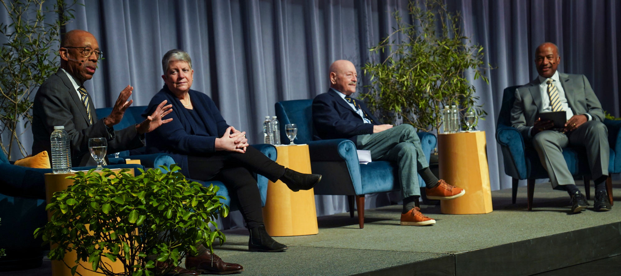 Three UC presidents and Chancellor May, on stage