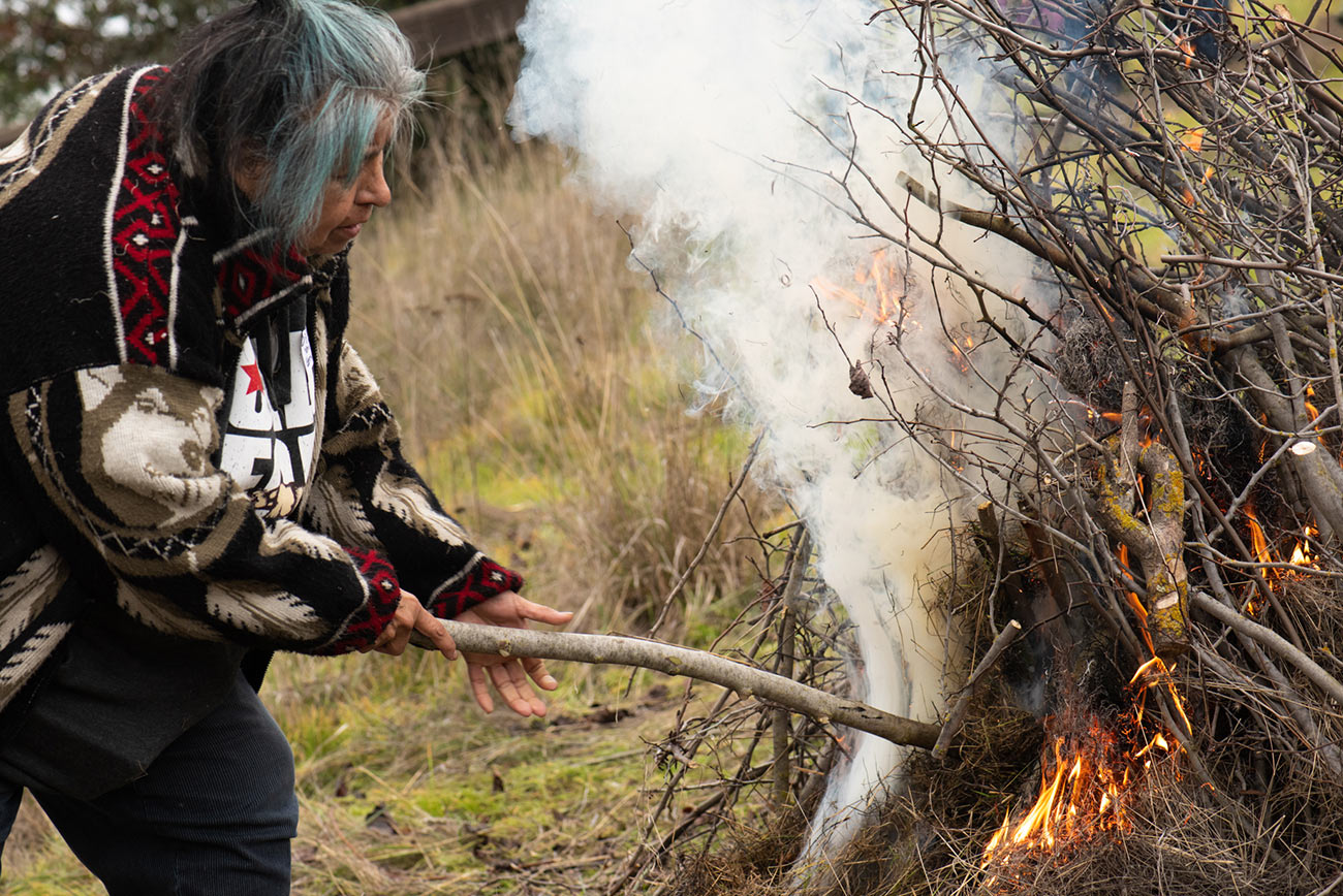 Diana Almendariz burning redbud pile