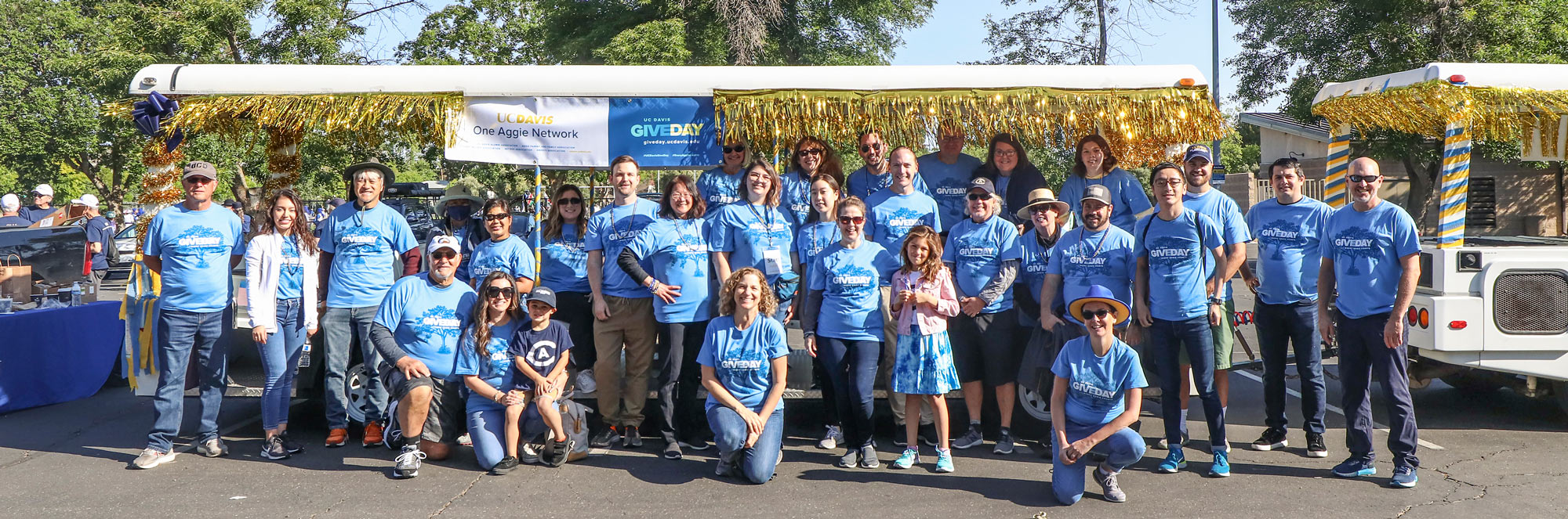 Give Day crew, posed, in light-blue "Give Day" T-shirts