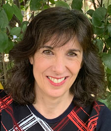 Portrait of a woman in front of greenery