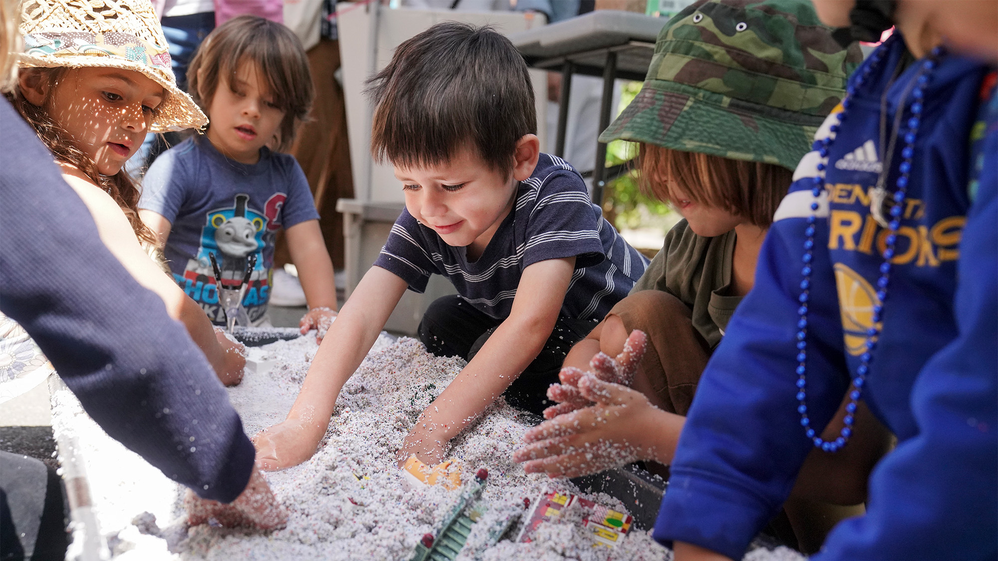 Children play in sandy exhibit at Picnic Day.