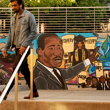 law student walks through courtyard at uc davis school of law