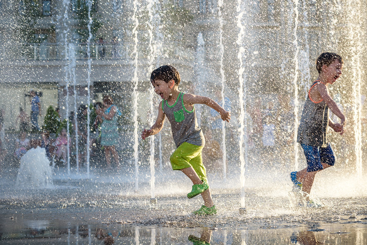 children dancing in water