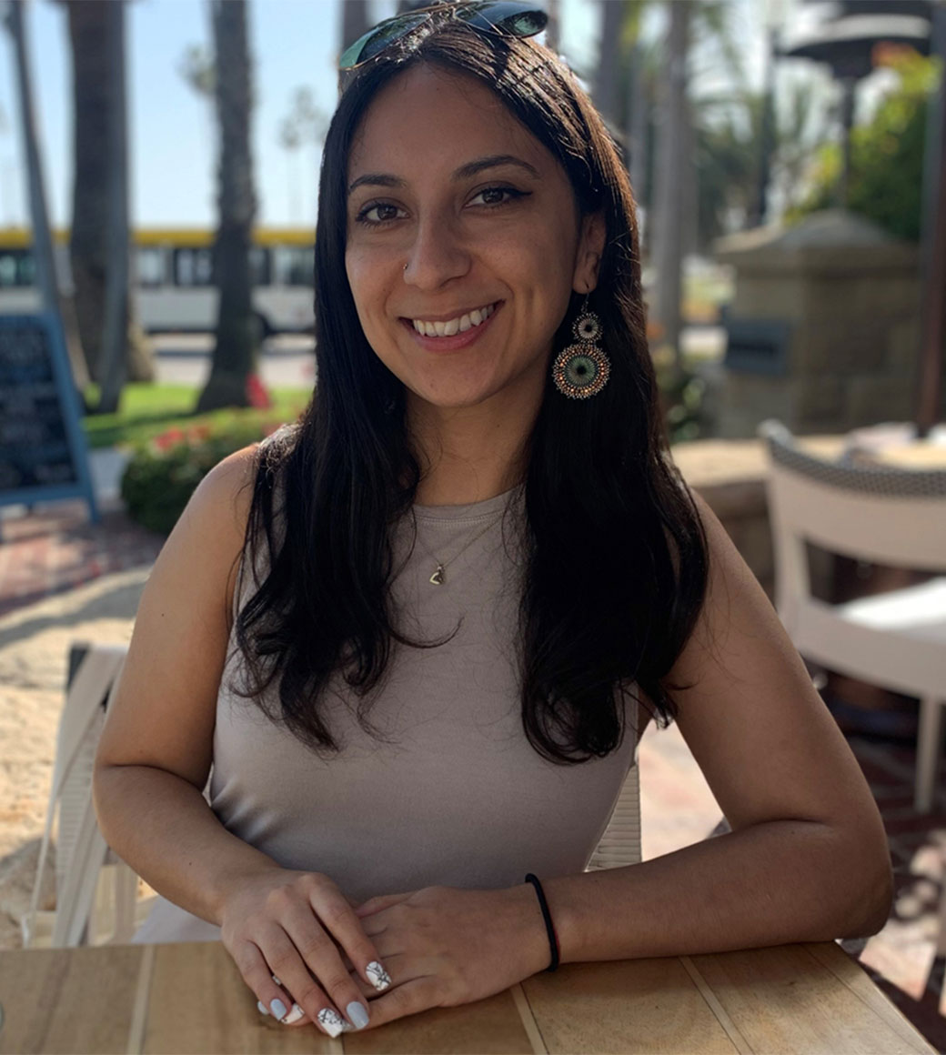 Youvanna Jimenez sitting outside and smiling for a photo.