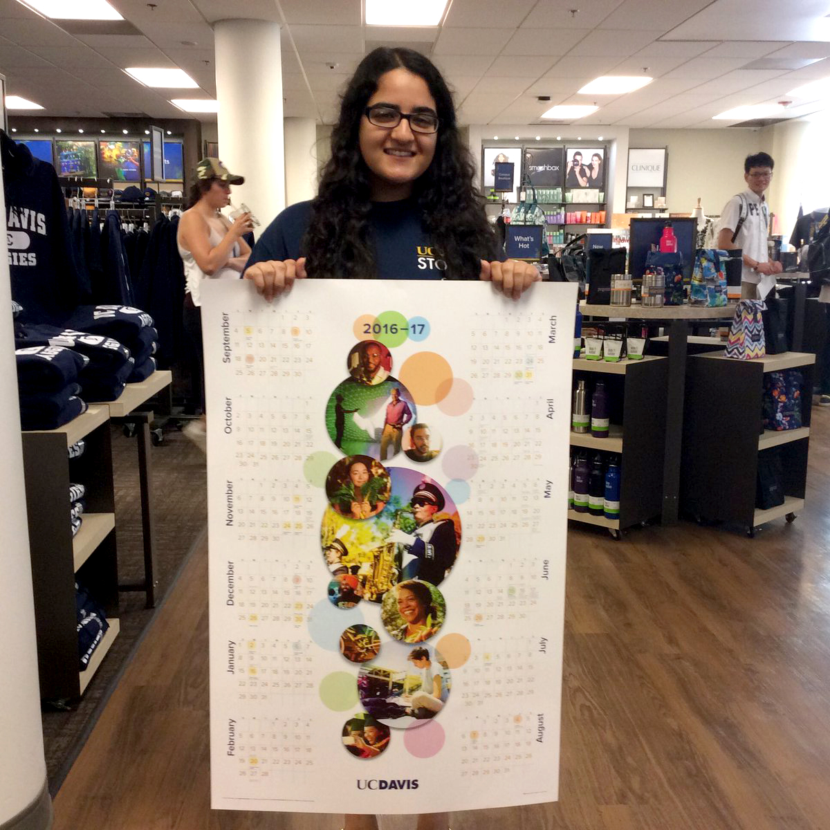 A student holds a poster calendar.