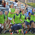 The UC Davis Women's Soccer team celebrates.