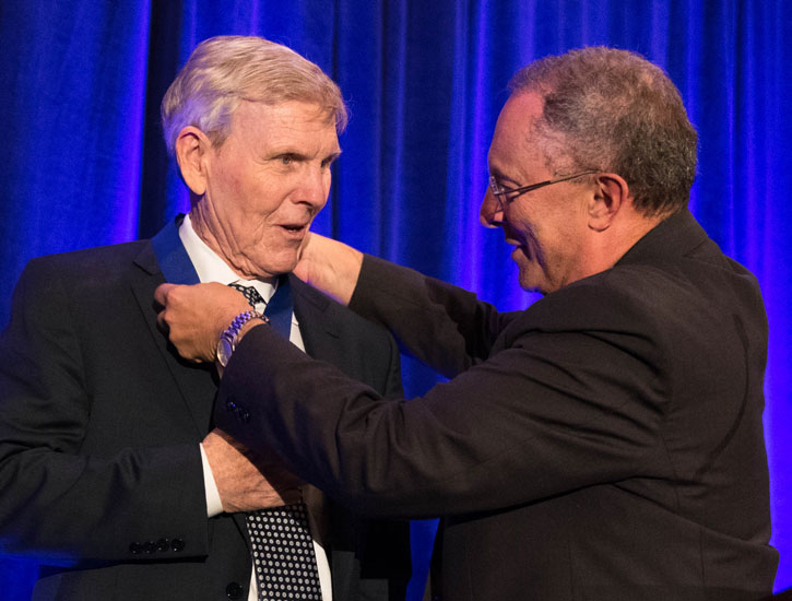 Ralh Hexter places medal on Bruce Edwards.