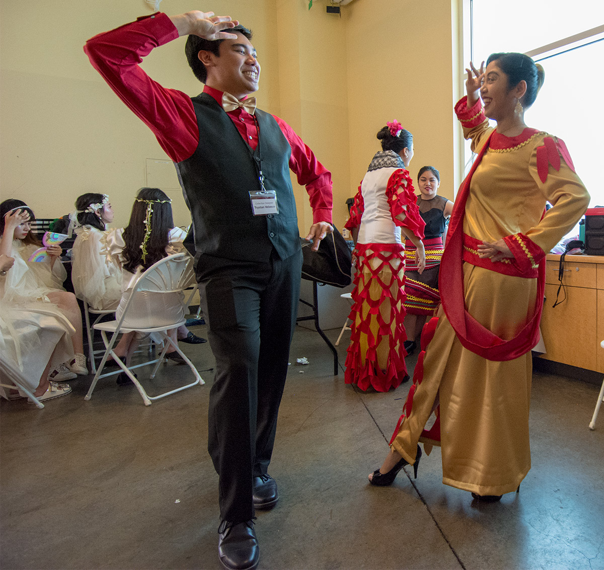 Trystan Velasco demonstrates pose backstage at fashion show.