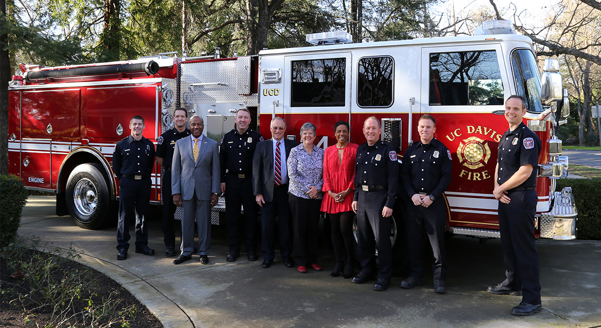 Group poses with fire engine.