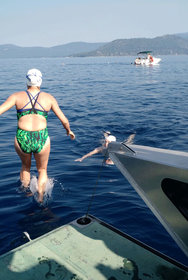 Woman jumps from boat into Lake Tahoe.