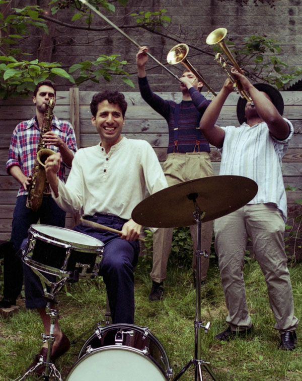 Sammy Miller at the drums, others behind him on sax, trombone and trumpet