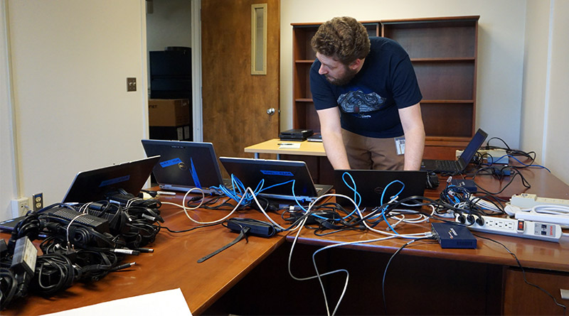 Man working on multiple laptops