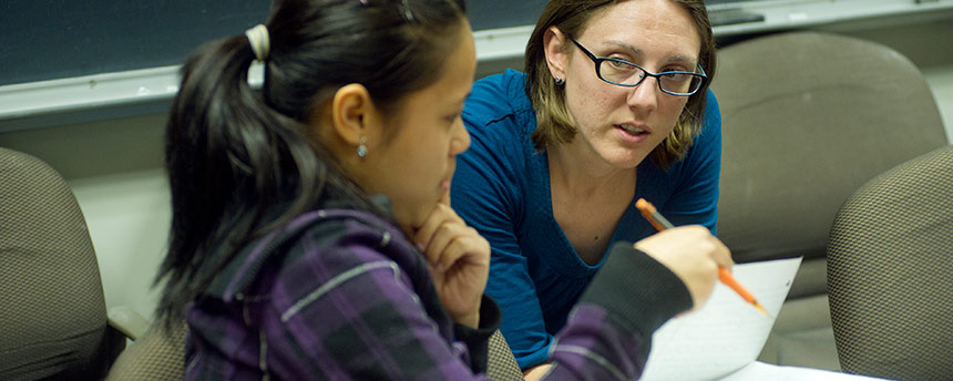 Female student getting tutoring from a woman in a classroom