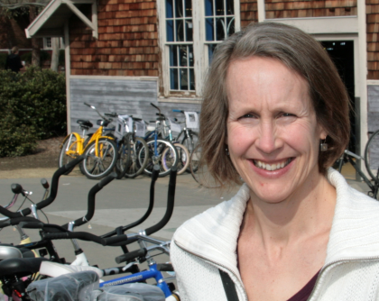 Woman by bicycles