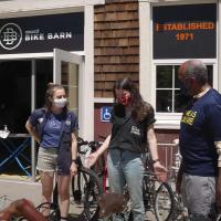 Chancellor May talking to some staff members outside in front of the Bike Barn