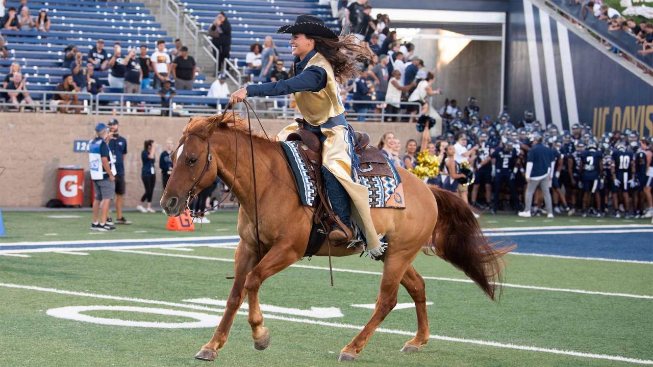 Maggie the Aggie rides onto football field