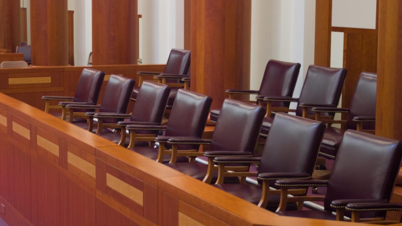 Scene in courtroom with chairs in jury box