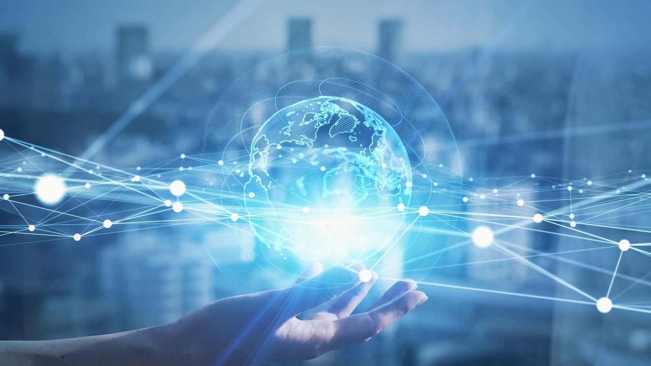 Abstract image of a transparent globe hovering over an open hand against a blue background. 