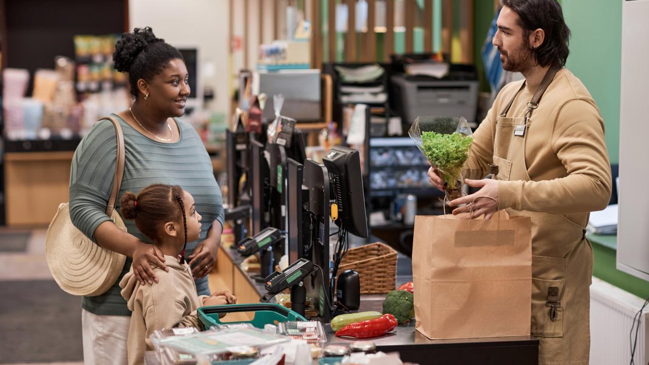 Woman and child at checkout stand buying groceries