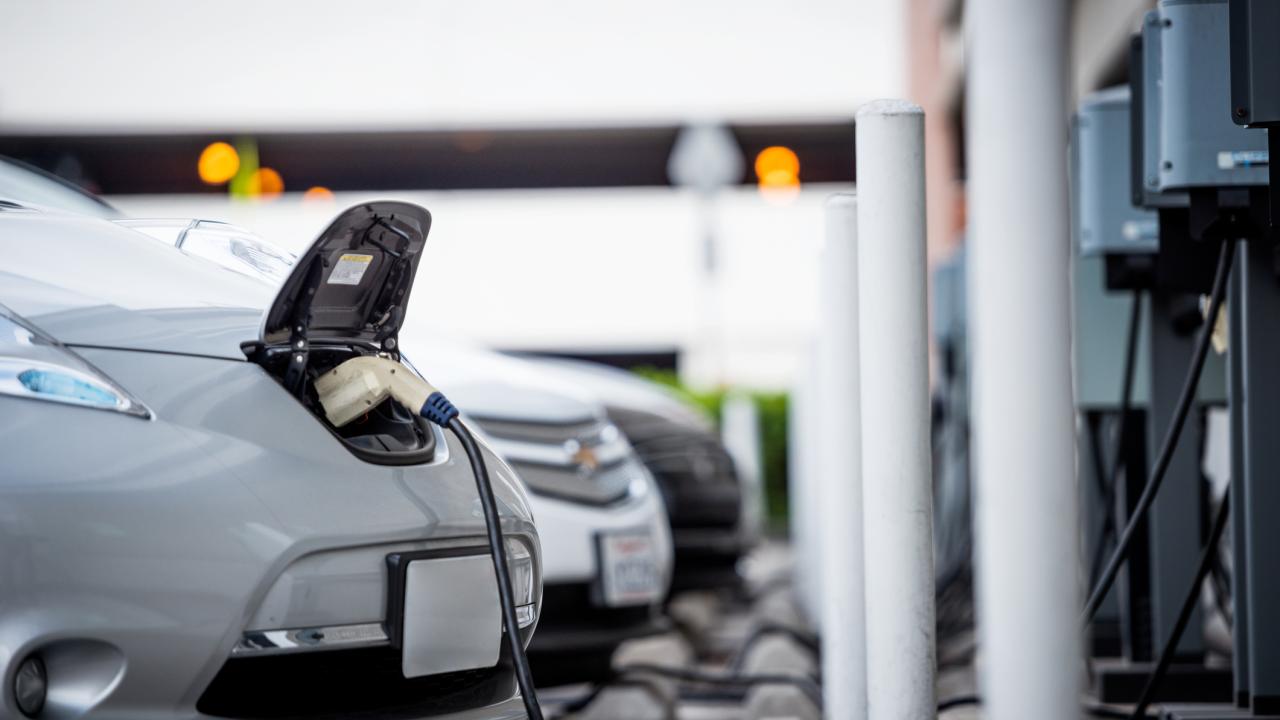 Electric vehicles charge in a parking garage