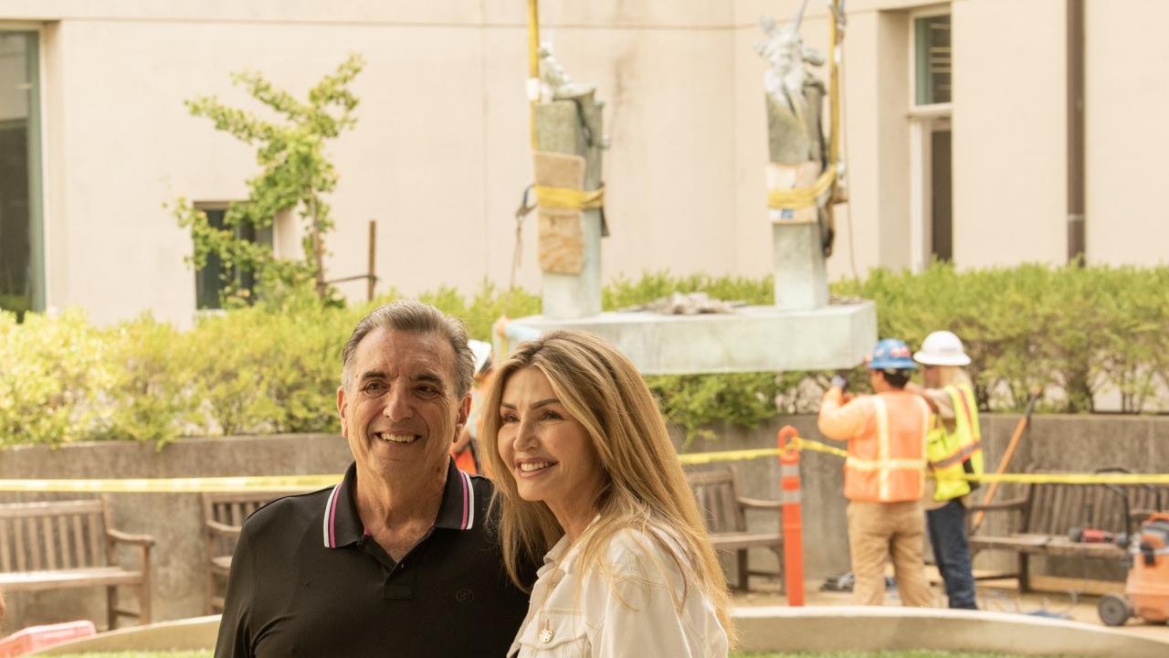 Couple in foreground and sculpture is loaded in background at UC Davis Library