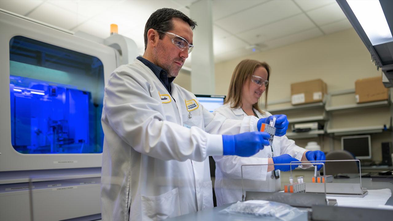 Two researchers test samples in a laboratory setting