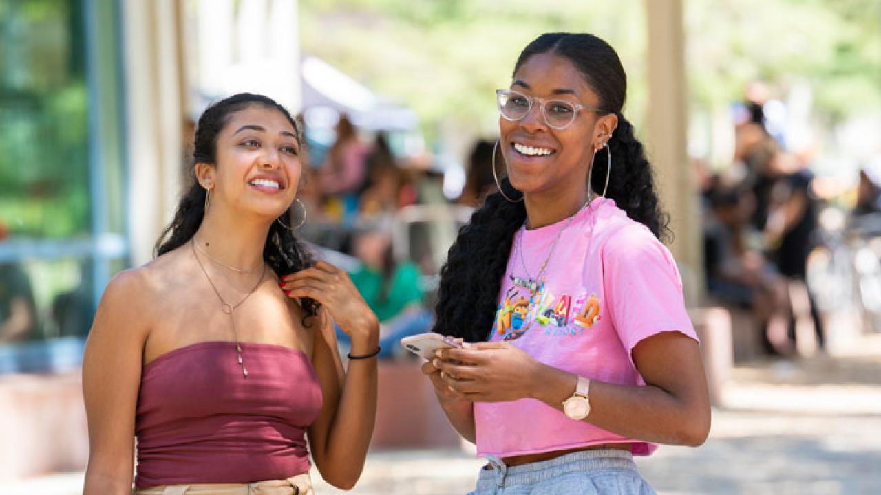 two students hanging in front of the Memorial Union