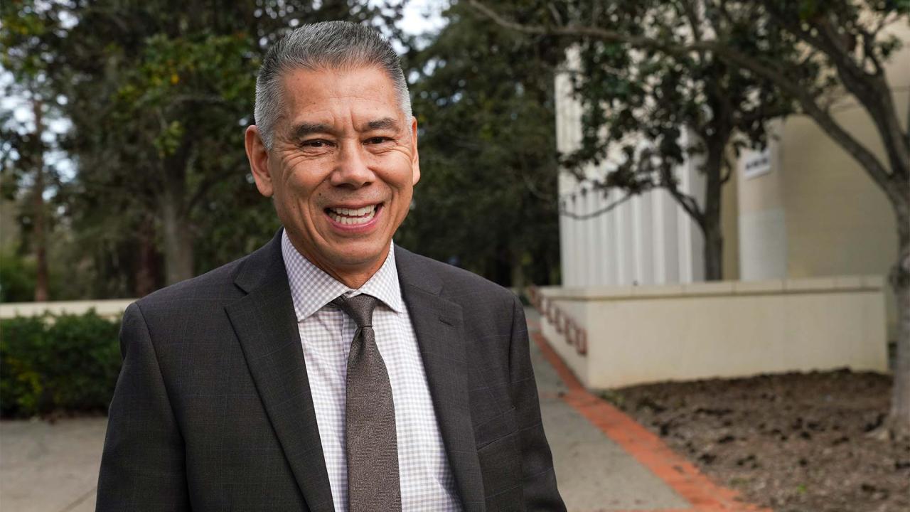 Joe Farrow in suit, smiling.