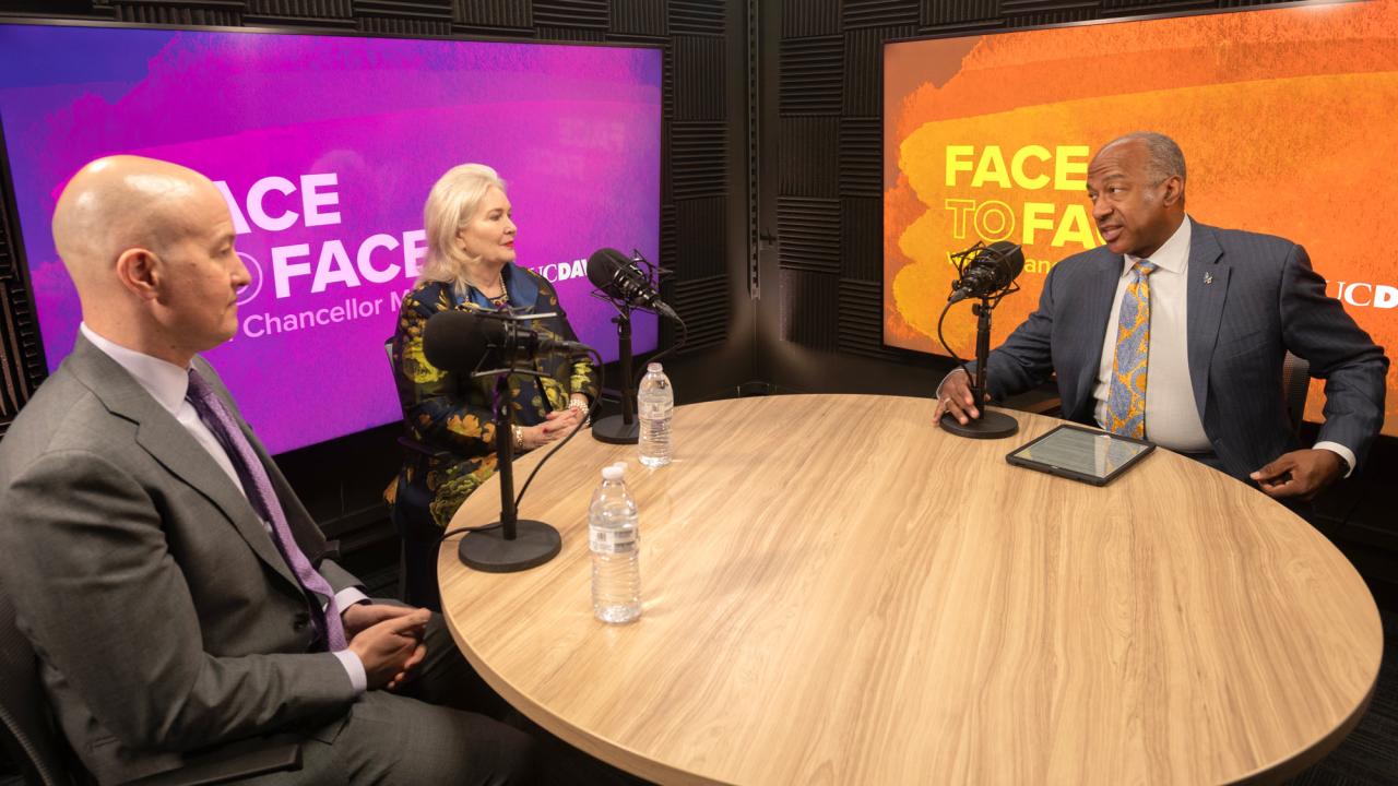 Chancellor Gary S. May with two others at round table with microphones, during recording of "Face to Face With Chancellor May"