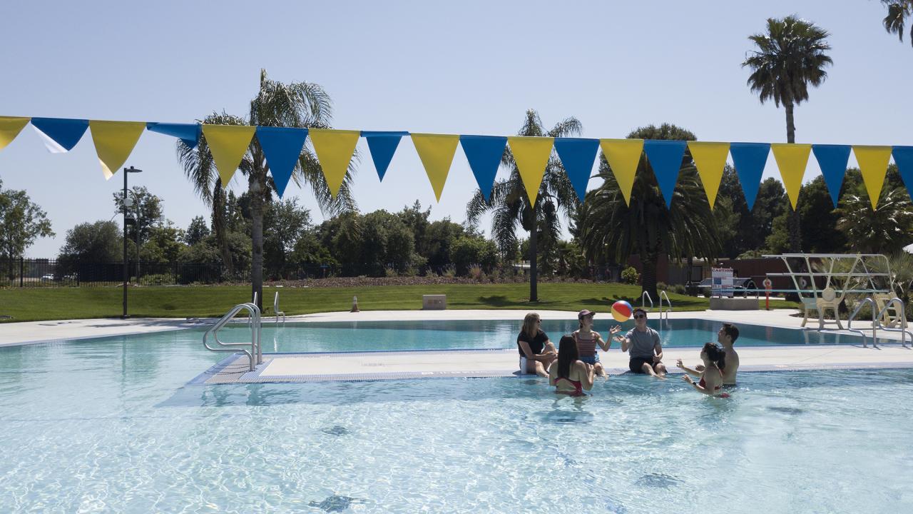 Students enjoy a day in the Rec Pool and play with a beach ball.