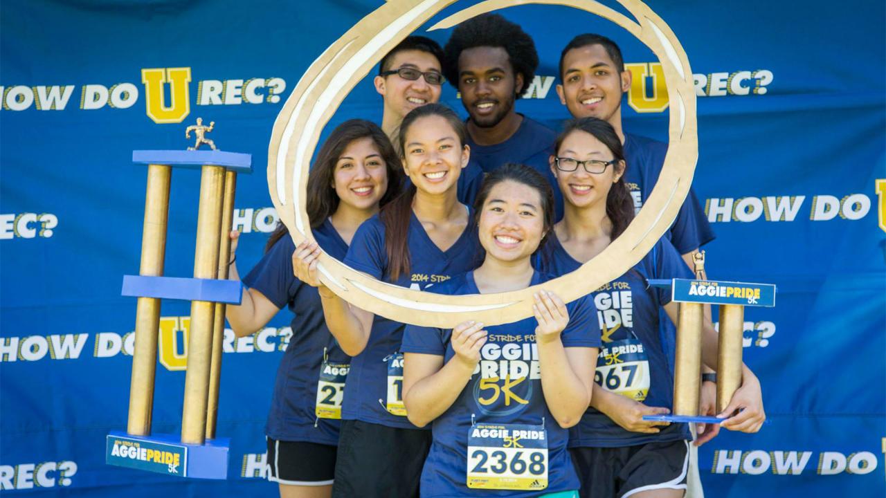 Runners pose in photo booth.