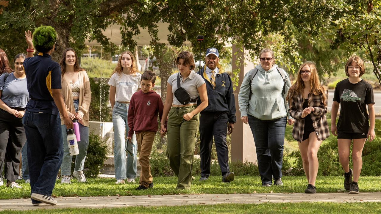 Chancellor Gary S. May accompanies students and their families on a tour