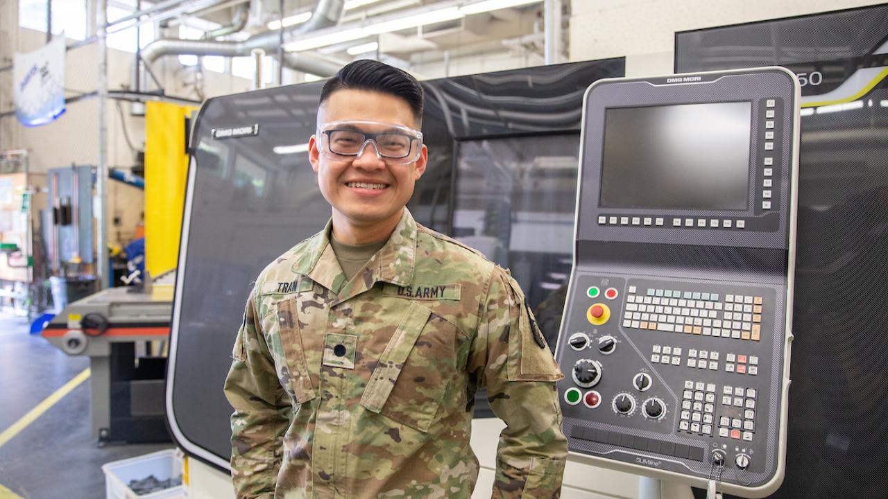 student dressed in military fatigues in a lab