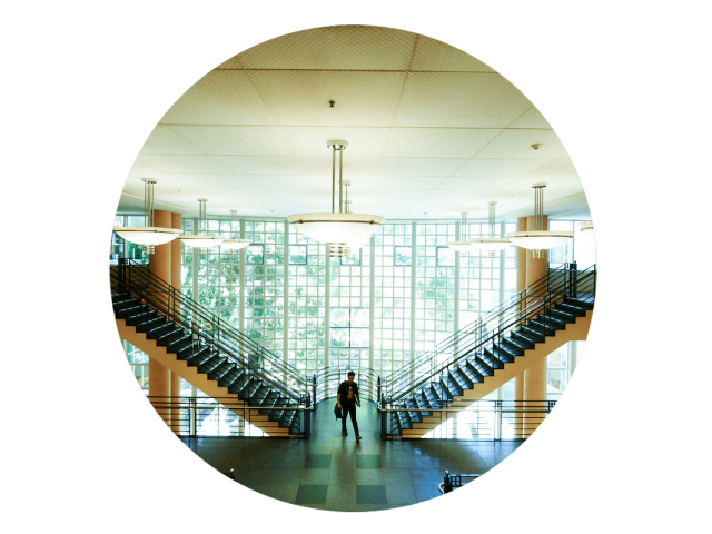 A student standing on the stairway in the library