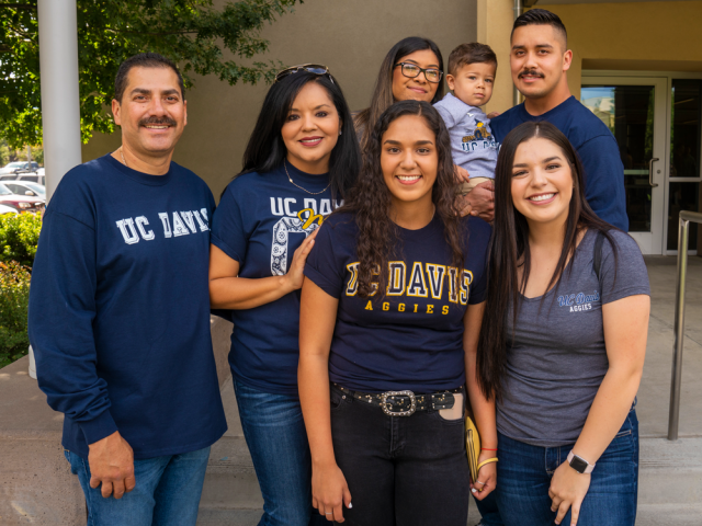 a family posing for a portrait in front of a building