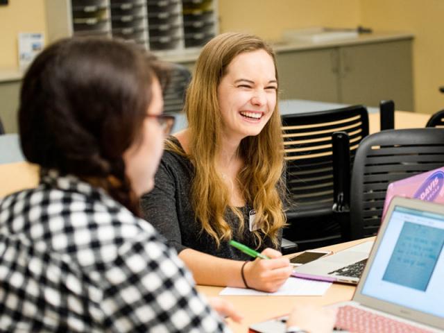 two students discuss one of their assignments