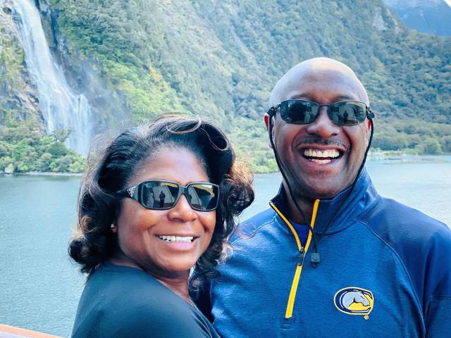 Lois and Darryl Goss outside near a waterfall