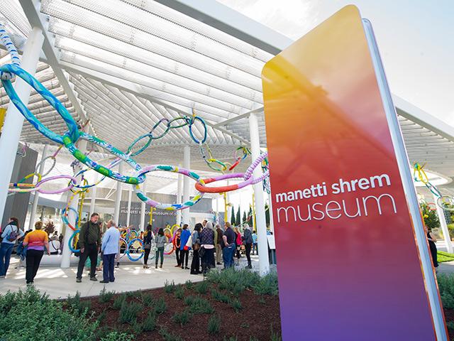 people gathered in front of the Manetti Shrem Museum of Art