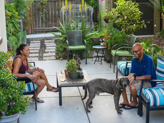 Scott Stevenson and his wife play with their dog on their back porch