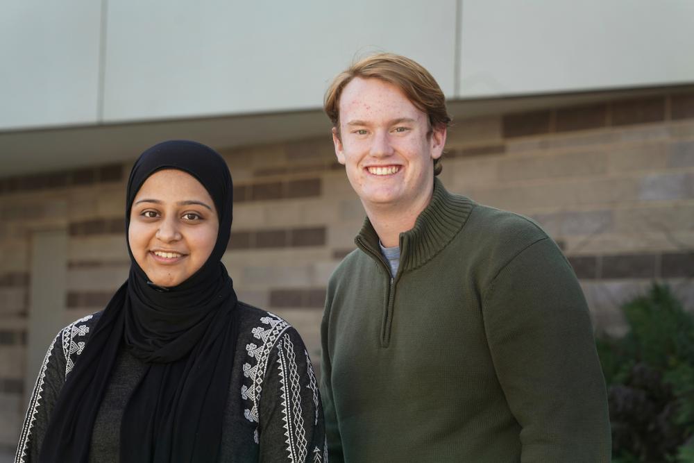 Two students pose outside a building at UC Davis. 