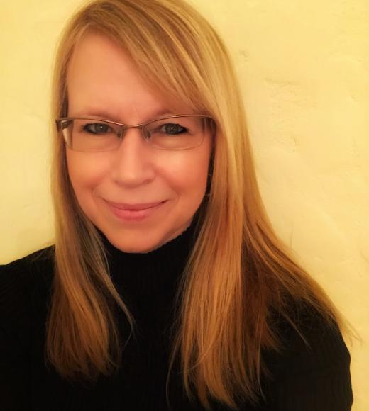 Headshot of female scientist glasses long hair